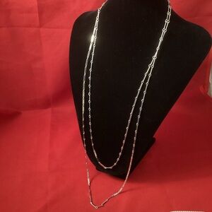 Very long silver tone metallic pieces chain
